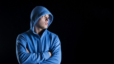 Athlete wearing a hoodie with his arms crossed