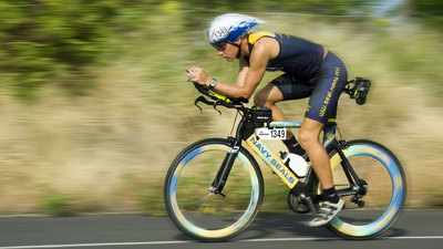 Triathlete cycling while using aero bars