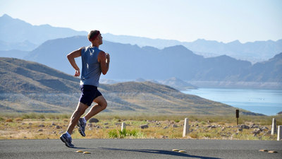 Man running in front of the mountains